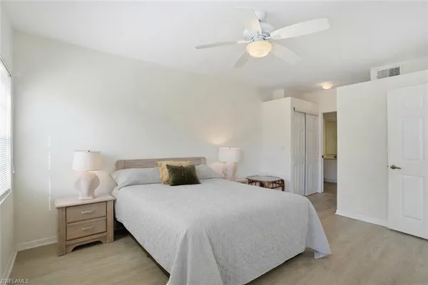 a bedroom with a bed and a ceiling fan