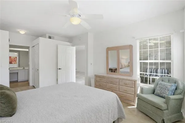 a spacious bedroom with a bed and a couch