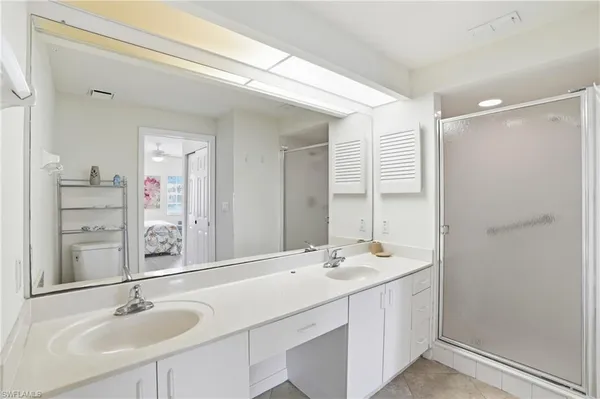a bathroom with a sink double vanity and a mirror