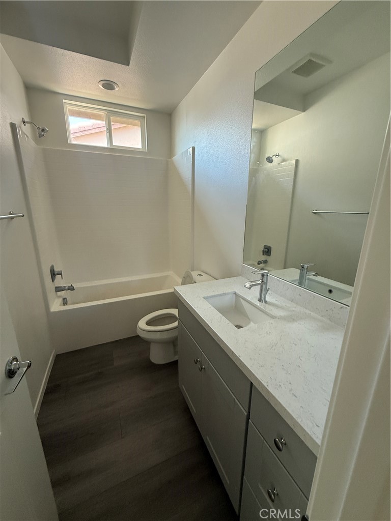 13404 Limestone Drive Yucaipa, CA 92399 - Photo 3 of 4 a bathroom with a granite countertop sink toilet and shower