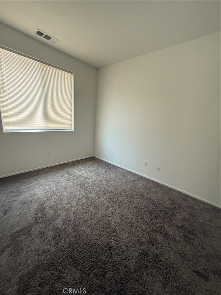 13404 Limestone Drive Yucaipa, CA 92399 - Photo 4 of 4 an empty room with a window