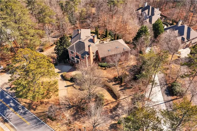 an aerial view of a house with a yard