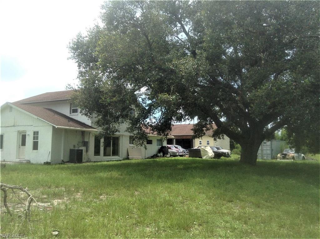 2781 Cecil Road Naples, FL 34114 - Photo 6 of 18 Rear View with Oak and Detached Garage in background
