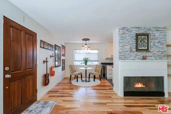 a living room with furniture potted plant and a table