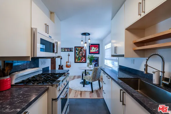 a kitchen with stainless steel appliances a refrigerator and a stove
