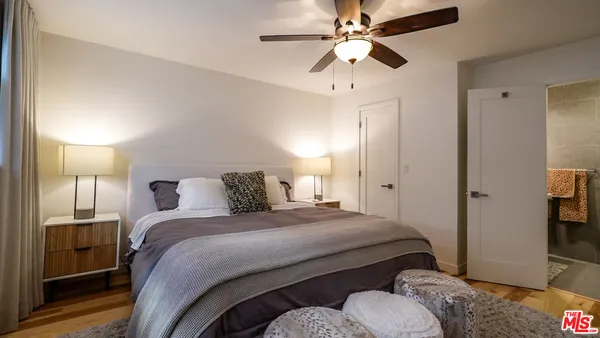 a bedroom with a bed and a chandelier