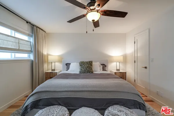 a bedroom with a bed and a chandelier