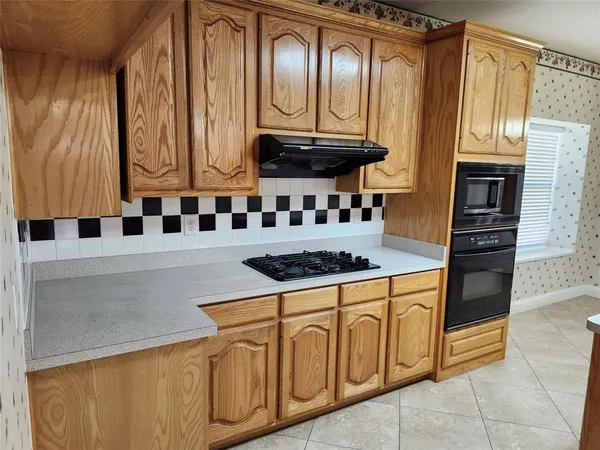 a kitchen with stainless steel appliances granite countertop a stove and a microwave
