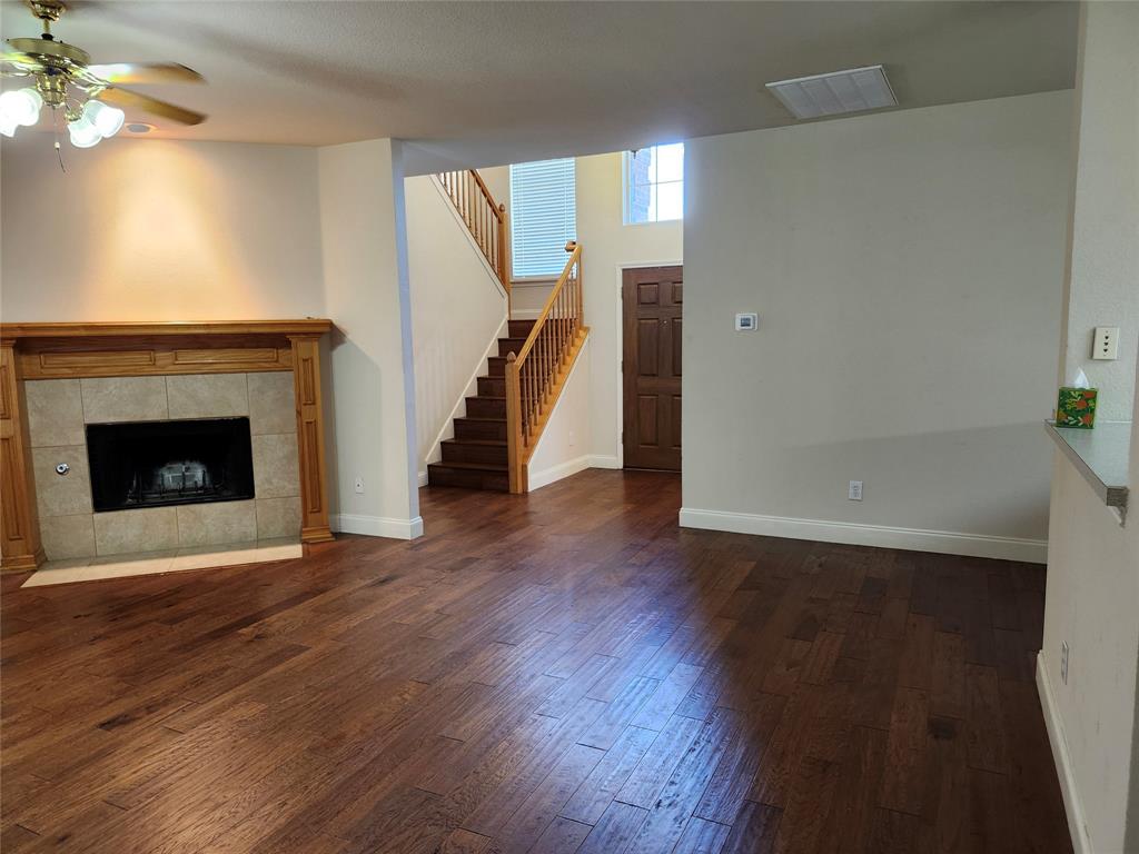 1329 Kingsley Court Allen, TX 75013 - Photo 8 of 13 wooden floor fireplace and natural light in room
