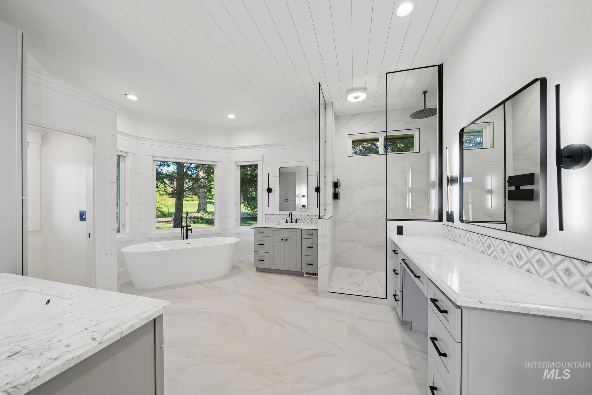 2050 Artesian Road Eagle, ID 83616 - Photo 25 of 49 Spacious room with wood-finish flooring, recessed lighting, crown molding, a large bay window, and a clear doorway to an adjoining bathroom