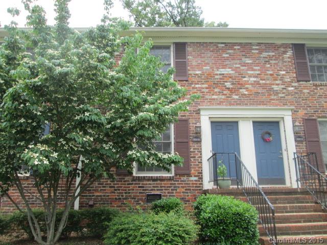 a front view of a house with plants