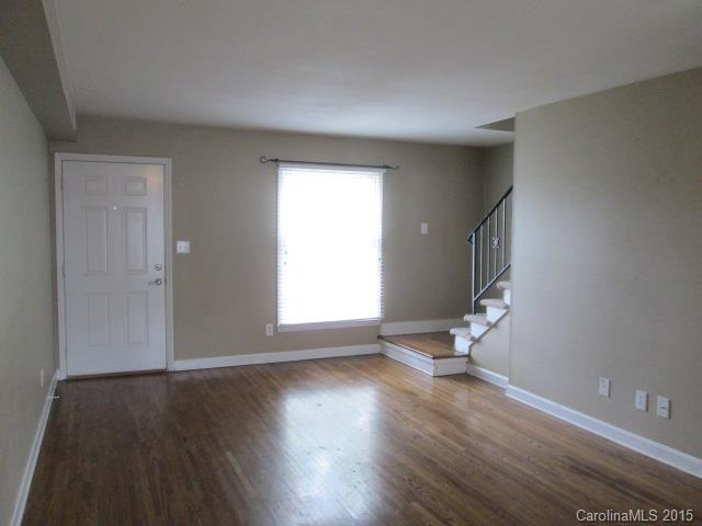 4327 Walker Road, Unit B Charlotte, NC 28211 - Photo 2 of 5 an empty room with wooden floor and a window
