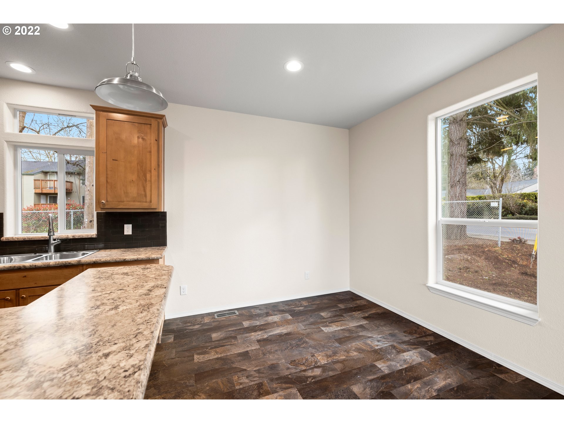 9700 Southwest Tualatin Road, Unit 12 Tualatin, OR 97062 - Photo 18 of 30 a view of an empty room with window and wooden floor