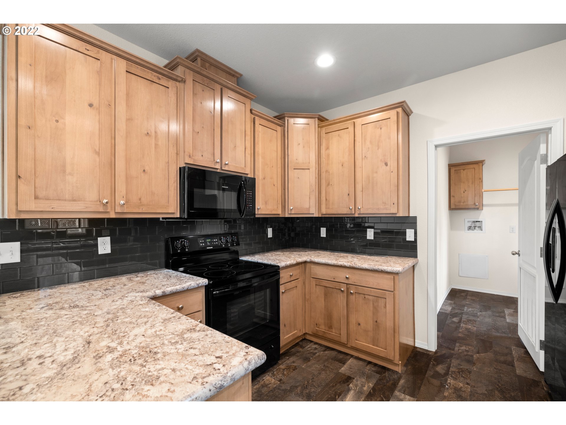 9700 Southwest Tualatin Road, Unit 12 Tualatin, OR 97062 - Photo 21 of 30 a kitchen with a stove a sink and a microwave