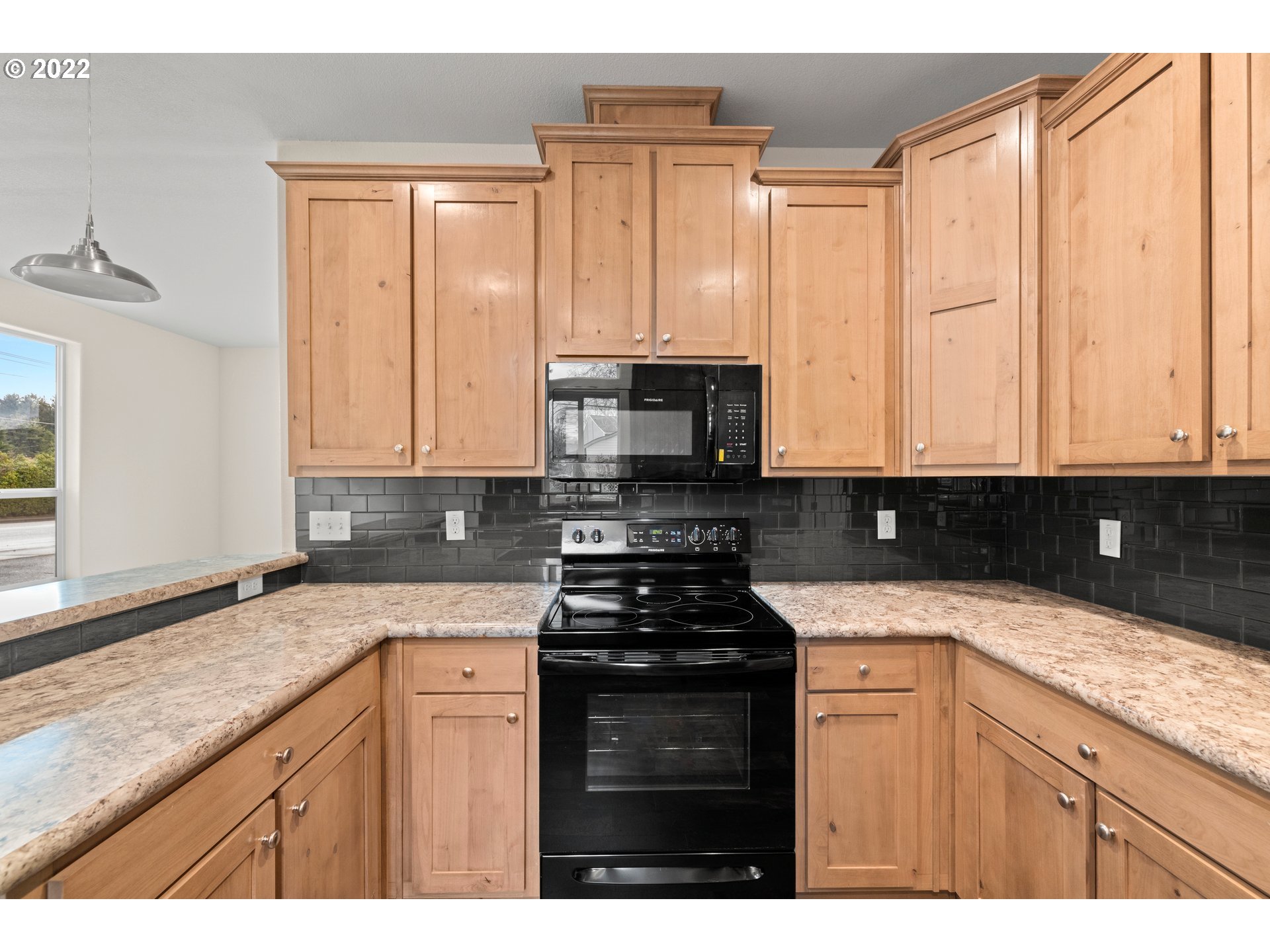 9700 Southwest Tualatin Road, Unit 12 Tualatin, OR 97062 - Photo 22 of 30 a kitchen with granite countertop a sink a stove and cabinets
