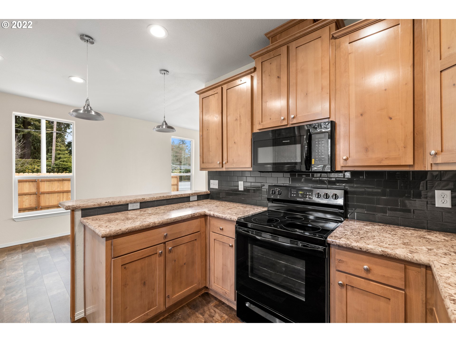 9700 Southwest Tualatin Road, Unit 12 Tualatin, OR 97062 - Photo 23 of 30 a kitchen with stainless steel appliances granite countertop a stove a sink and a microwave