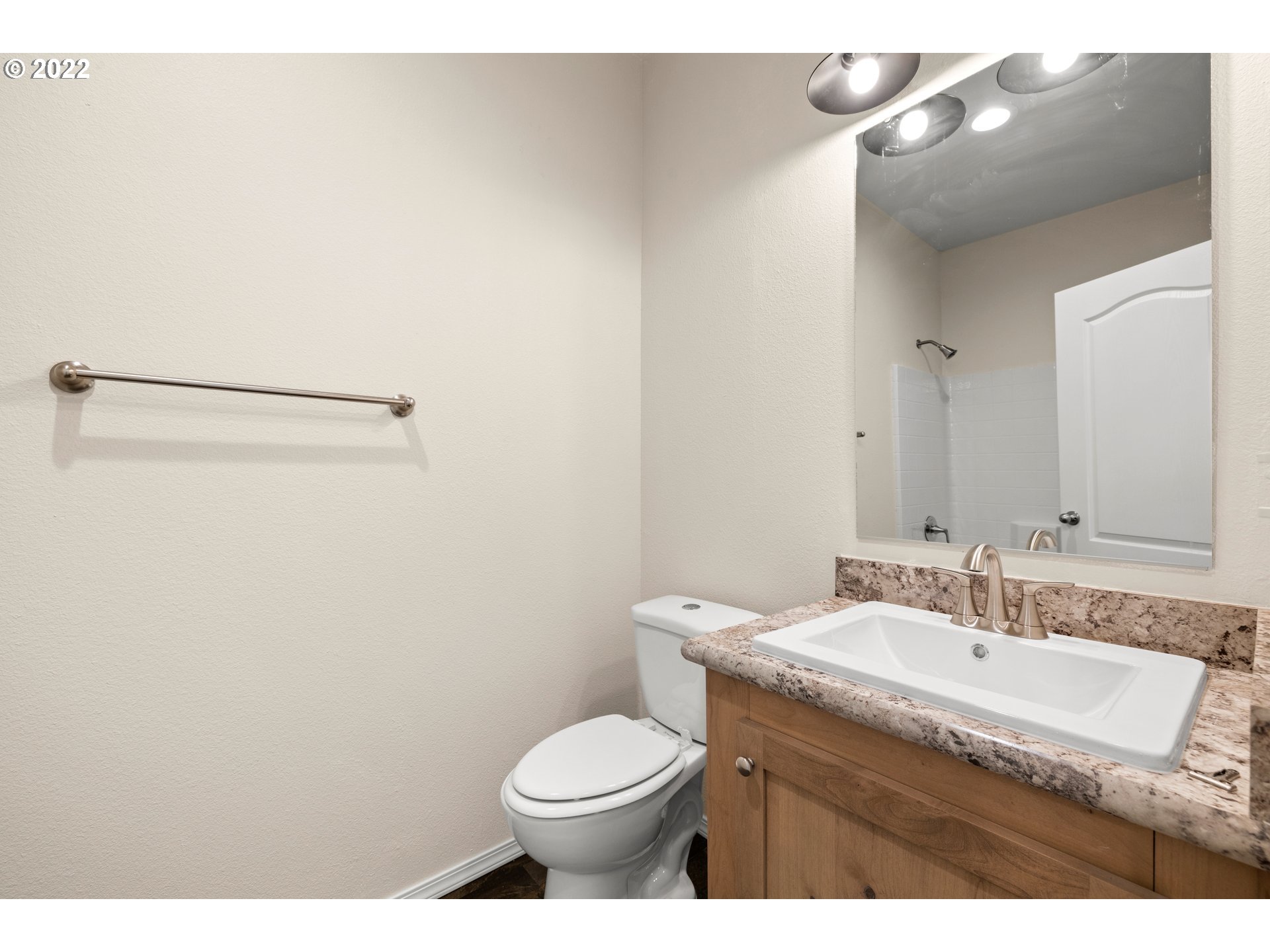 9700 Southwest Tualatin Road, Unit 12 Tualatin, OR 97062 - Photo 3 of 30 a bathroom with a granite countertop sink and a mirror