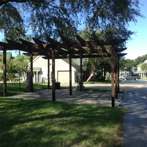 a view of a porch with a table and chairs under an umbrella