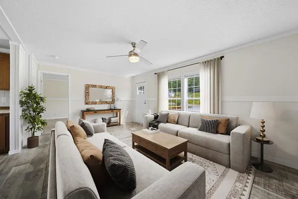 a living room with furniture and a large window