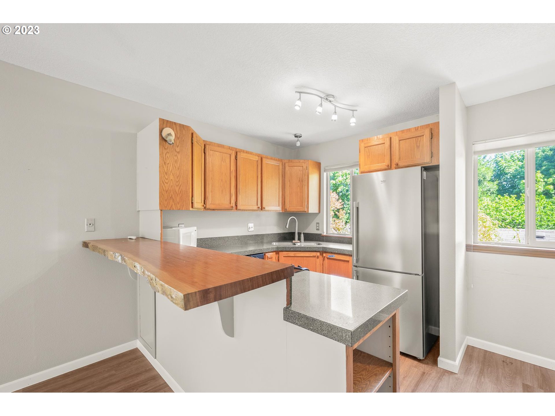 2785 Northwest Upshur Street, Unit B Portland, OR 97210 - Photo 14 of 35 a kitchen with stainless steel appliances granite countertop a refrigerator a sink and a stove