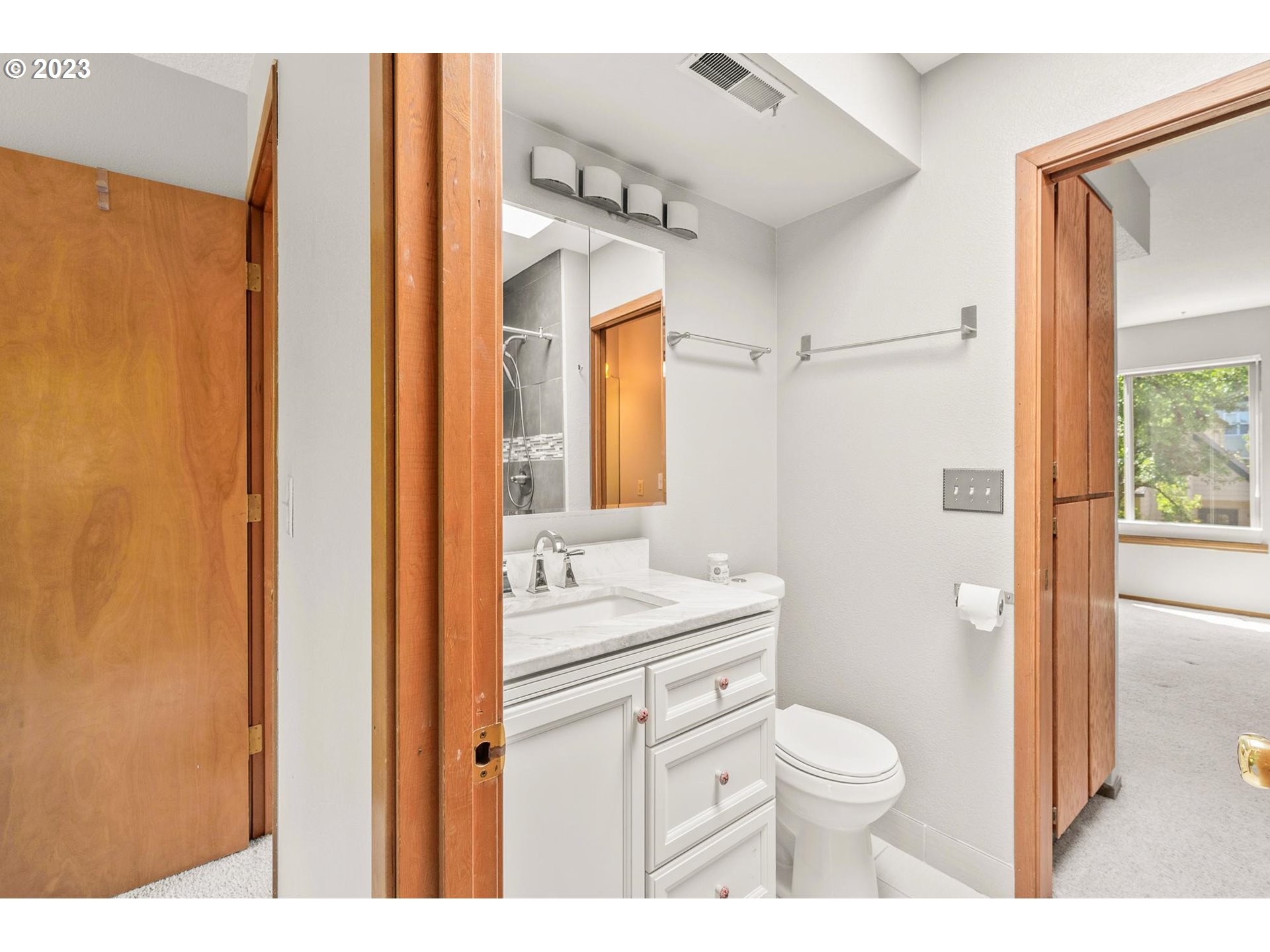 2785 Northwest Upshur Street, Unit B Portland, OR 97210 - Photo 19 of 35 a bathroom with a toilet a sink and a mirror