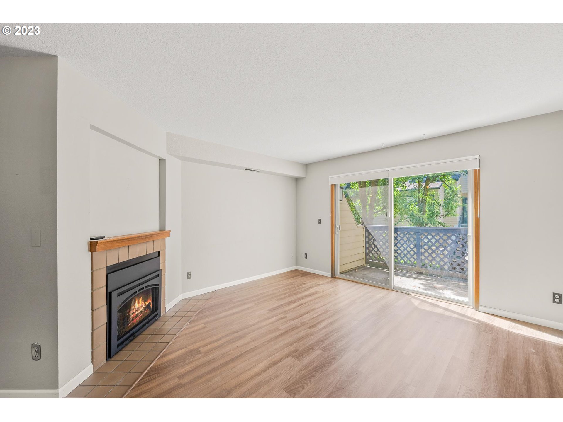 2785 Northwest Upshur Street, Unit B Portland, OR 97210 - Photo 3 of 35 a view of an empty room with wooden floor and a window