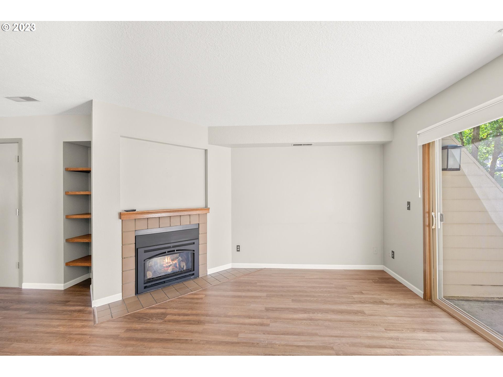 2785 Northwest Upshur Street, Unit B Portland, OR 97210 - Photo 4 of 35 a view of empty room with a fireplace and wooden floor