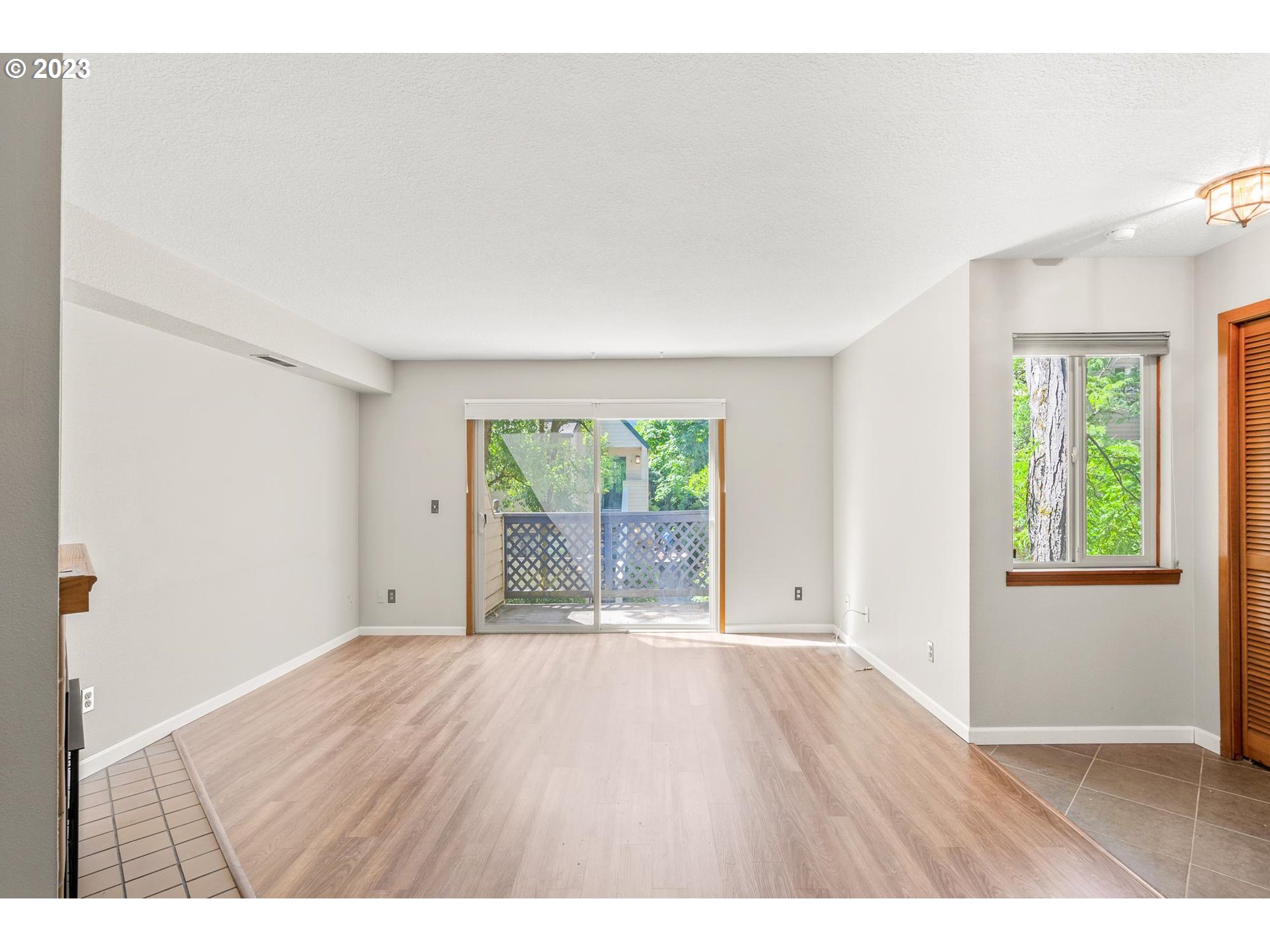 2785 Northwest Upshur Street, Unit B Portland, OR 97210 - Photo 6 of 35 a view of an empty room with wooden floor and a window