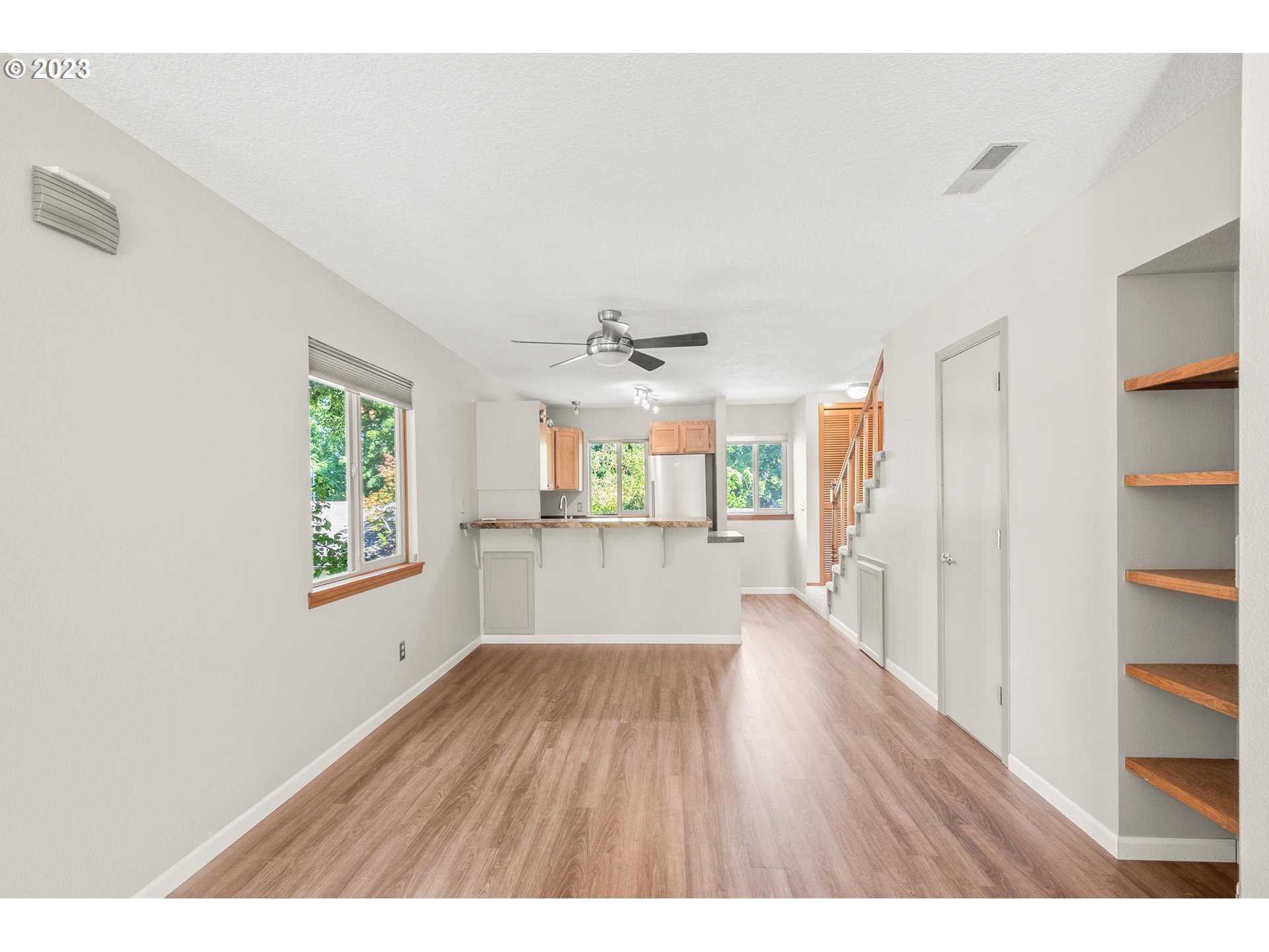 2785 Northwest Upshur Street, Unit B Portland, OR 97210 - Photo 7 of 35 a empty room with wooden floor ceiling fan and windows