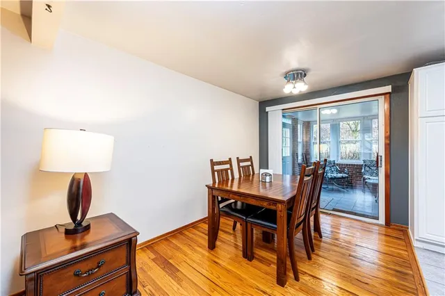 a dining room with furniture and wooden floor