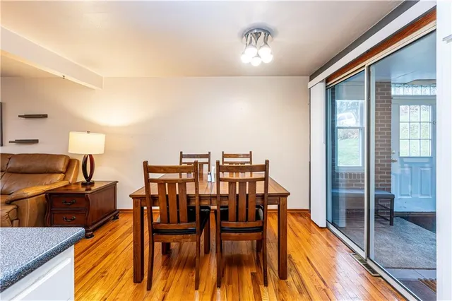 a dining room with furniture and wooden floor