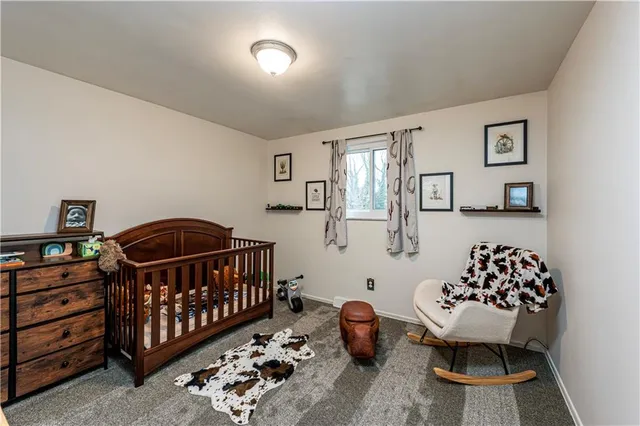 a bedroom with furniture and a baby crib