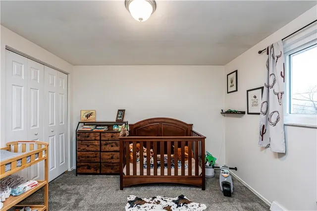 a bedroom with furniture and baby crib