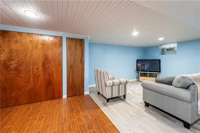 a bedroom with furniture and a wooden floor