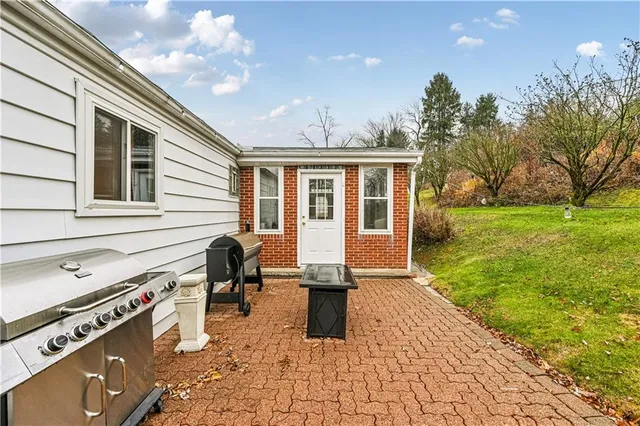 a view of a patio with a table and chairs and potted plants