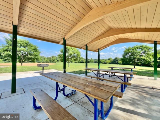 9012 Centerway Road Gaithersburg, MD 20879 - Photo 25 of 32 a view of a swimming pool with a bench and lawn chairs