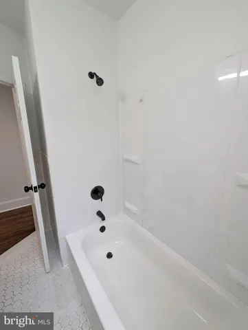 a bathroom with a tub and a shower