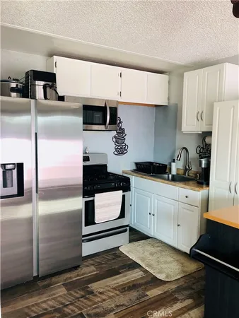 a kitchen with granite countertop stainless steel appliances and wooden cabinets