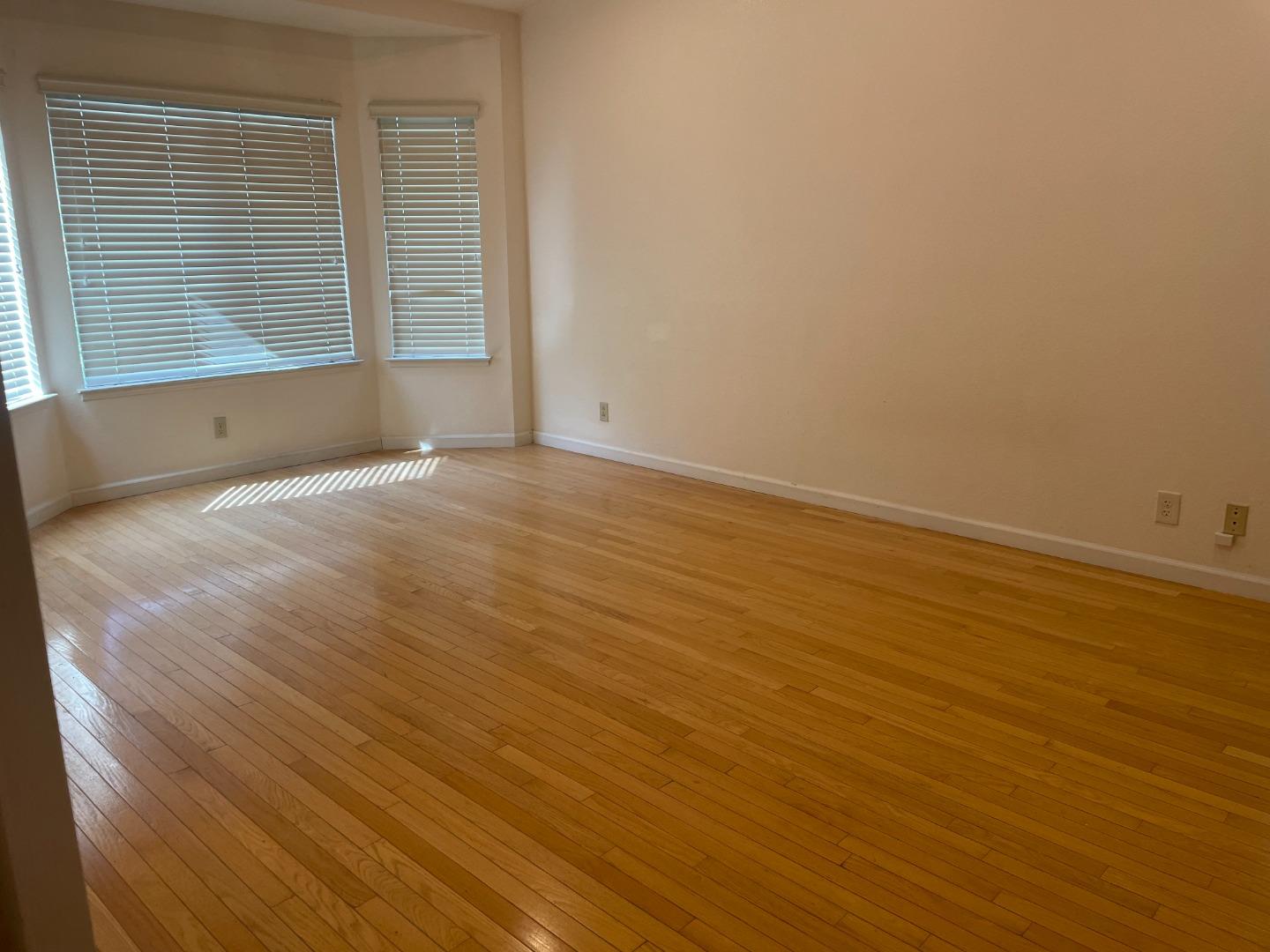 2294 Pinard Street Milpitas, CA 95035 - Photo 11 of 21 an empty room with wooden floor and windows