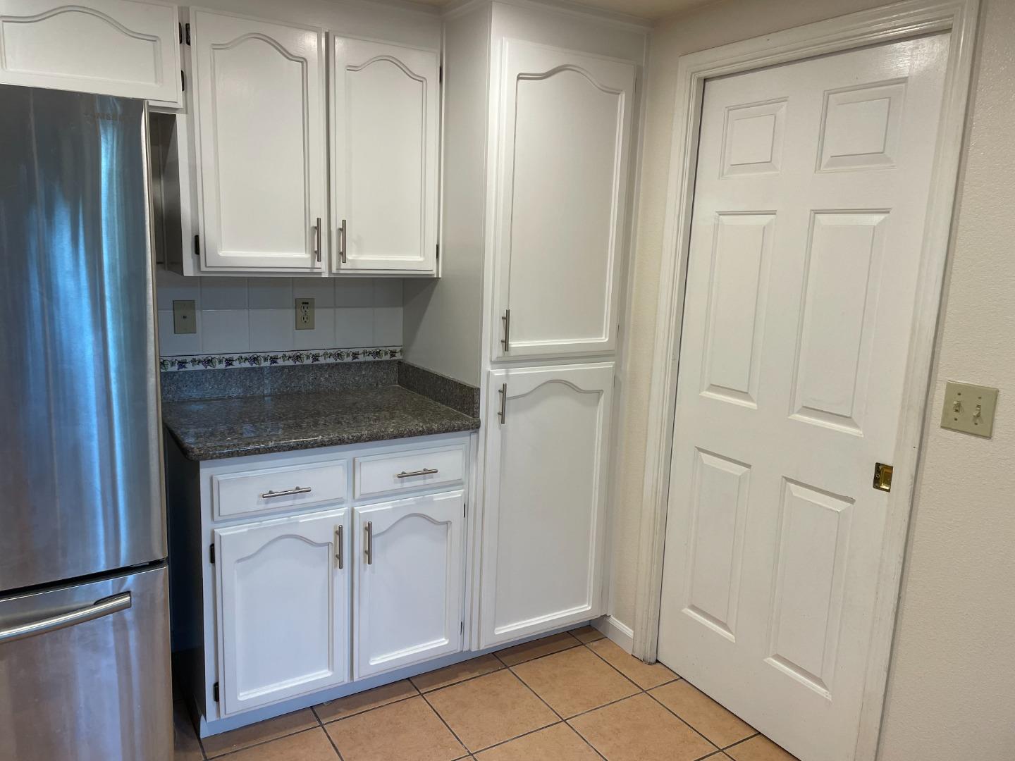2294 Pinard Street Milpitas, CA 95035 - Photo 7 of 21 a kitchen with white cabinets and refrigerator