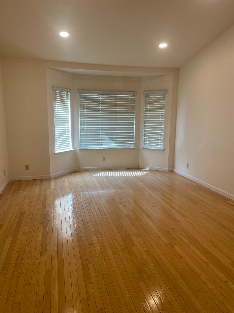 2294 Pinard Street Milpitas, CA 95035 - Photo 9 of 21 an empty room with wooden floor and windows