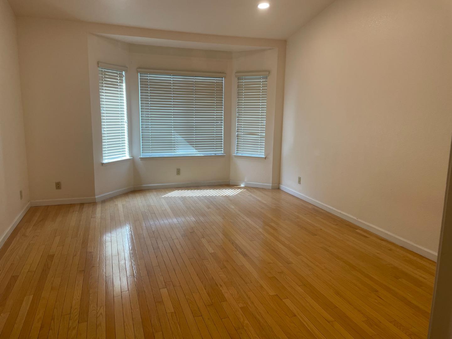2294 Pinard Street Milpitas, CA 95035 - Photo 10 of 21 an empty room with wooden floor and windows