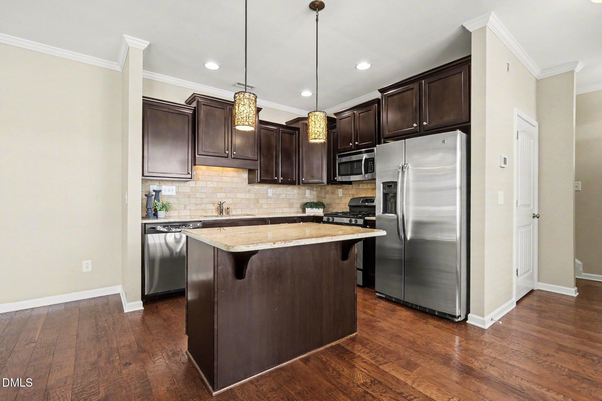 2409 Memory Ridge Drive Raleigh, NC 27606 - Photo 9 of 36 a kitchen with stainless steel appliances granite countertop a refrigerator a stove a sink and a microwave