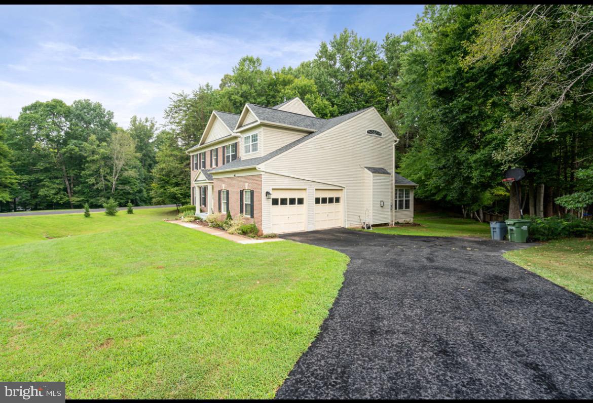 6540 Running Brook Road Manassas, VA 20112 - Photo 2 of 11 a view of a white house in front of a big yard with large trees