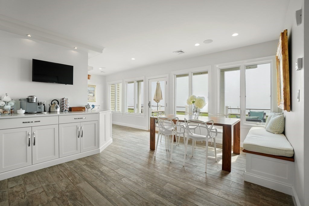 123 Gurnet Road Duxbury, MA 02332 - Photo 11 of 42 a living room with furniture a flat screen tv and floor to ceiling window