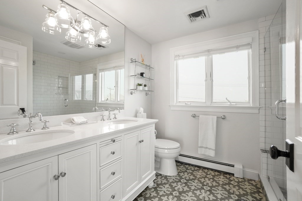 123 Gurnet Road Duxbury, MA 02332 - Photo 28 of 42 a bathroom with a granite countertop sink a toilet and a mirror