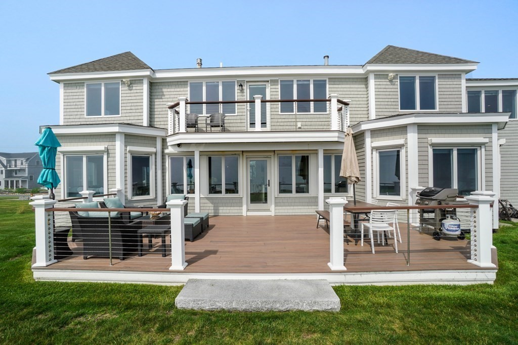 123 Gurnet Road Duxbury, MA 02332 - Photo 36 of 42 a front view of a house with a yard table and chairs