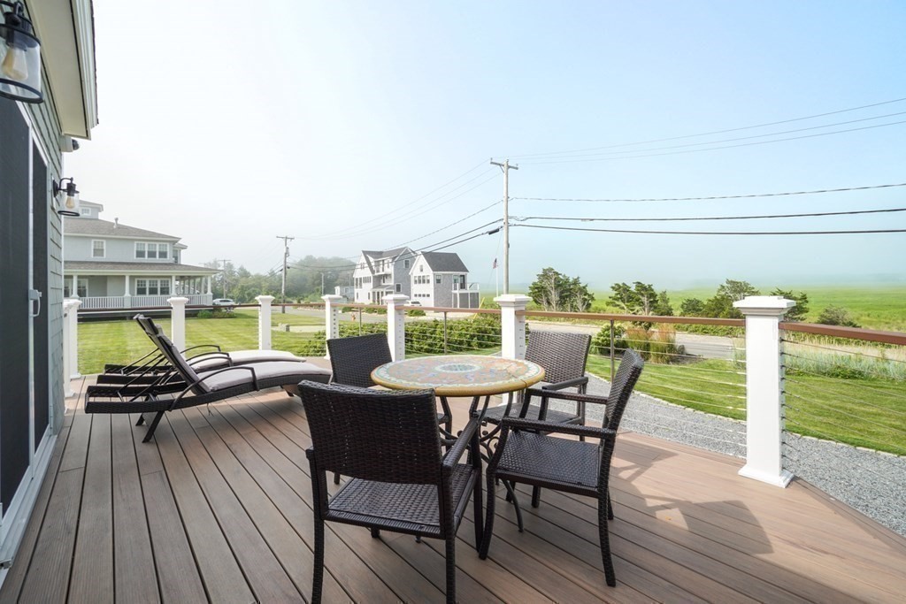 123 Gurnet Road Duxbury, MA 02332 - Photo 37 of 42 a view of a balcony with a table and chairs