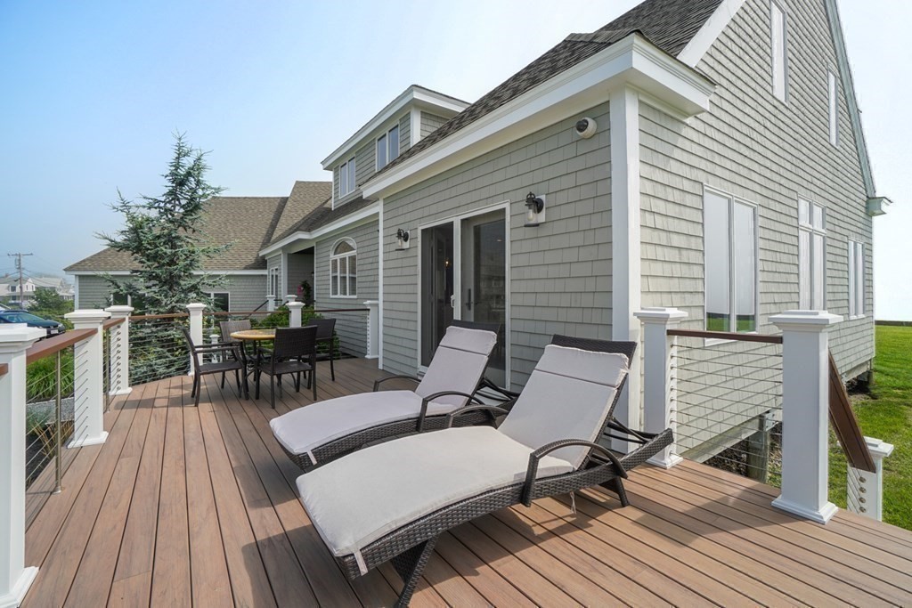 123 Gurnet Road Duxbury, MA 02332 - Photo 39 of 42 a view of a patio with table and chairs with wooden floor and fence