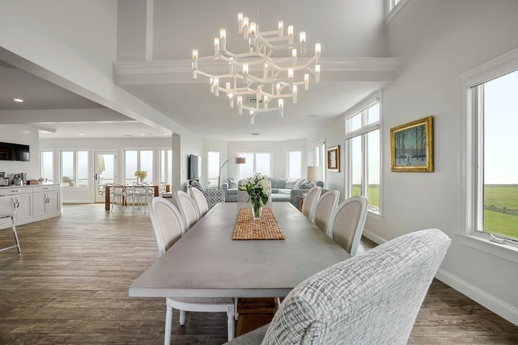 123 Gurnet Road Duxbury, MA 02332 - Photo 4 of 42 a view of a dining room with furniture a chandelier and wooden floor